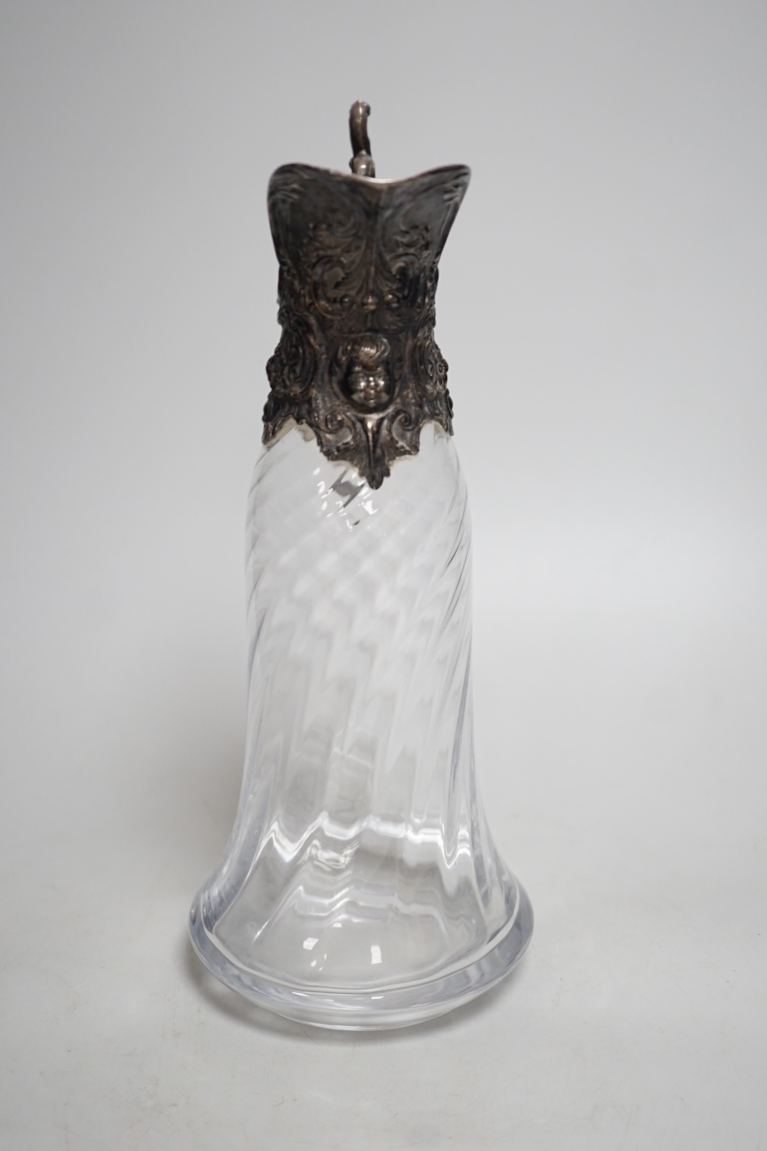 A Victorian rococo style electroplate mounted glass claret jug. 33cm tall